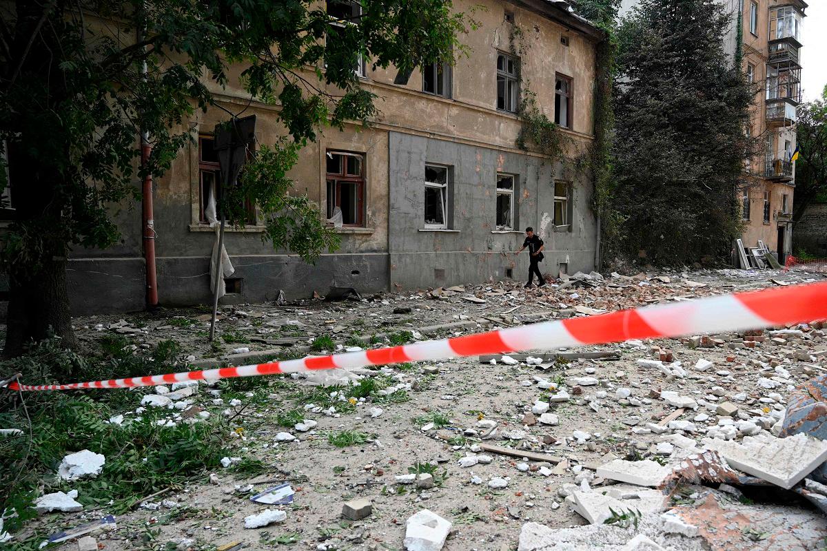 A man walks past a residential building damaged following Russian air attacks in the western Ukrainian city of Lviv on August 21, 2025, amid the Russian invasion of Ukraine. - YURIY DYACHYSHYN / AFP