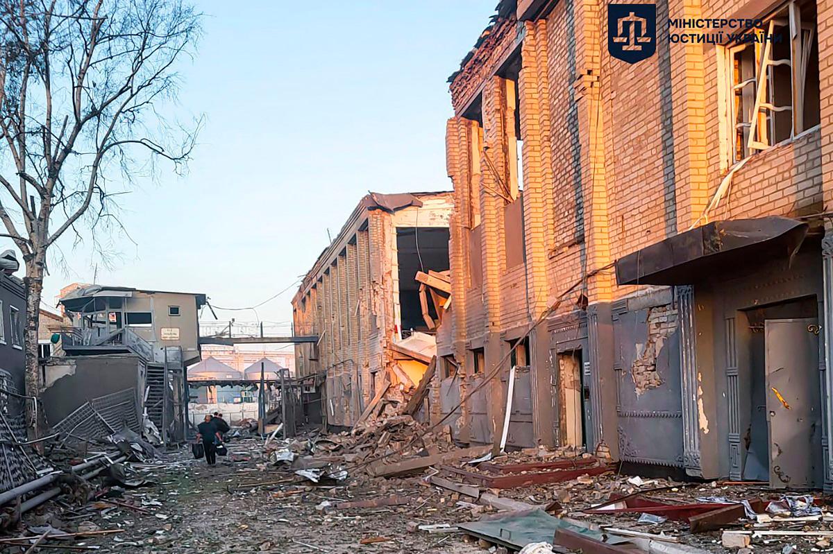 This handout photograph taken and released by the Ukrainian Justice Ministry on July 29, 2025, shows a man walking among debris next to a destroyed building of the Bilenkivska correctional colony following an air attack in Bilenke, Zaporizhzhia region, amid the Russian invasion of Ukraine. - AFP PHOTO / UKRAINIAN JUSTICE MINISTRY