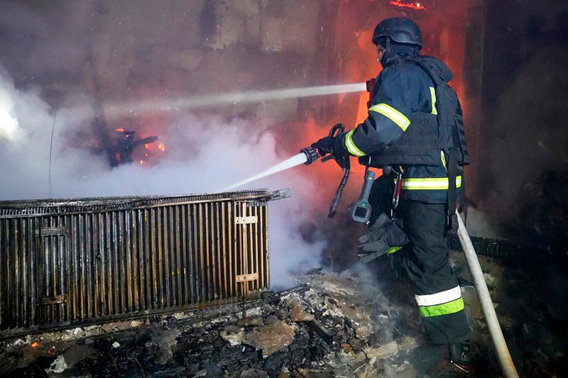 This handout photograph released by the Ukrainian Emergency Service early on March 5, 2025, shows a Ukrainian rescuer working to extinguish a fire in a building following an attack at an undisclosed location in Odesa region, amid the Russian invasion of Ukraine. Russia attacked energy facilities in the southern Ukrainian region of Odesa overnight, officials said on March 5, 2025, cutting electricity supplies to the Black Sea territory and leaving at least two dead. - AFP PHOTO / UKRAINIAN EMERGENCY SERVICE