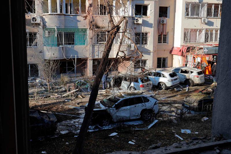 Local residents inspect damage to a residential building and cars following a missile attack in Odesa on November 18, 2024. The toll from a Russian missile strike on Ukraine’s Black November 18, 2024, Ukraine’s state emergency services said. - Oleksandr GIMANOV / AFPpix