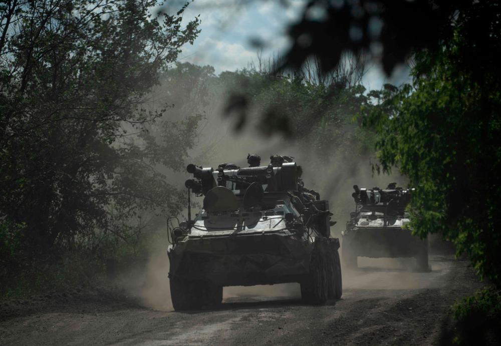 Ukrainian servicemen ride on armoured personnel carriers (APC) on a road toward Bakhmut, Donetsk region, on July 1, 2023, amid the Russian invasion of Ukraine. AFPPIX