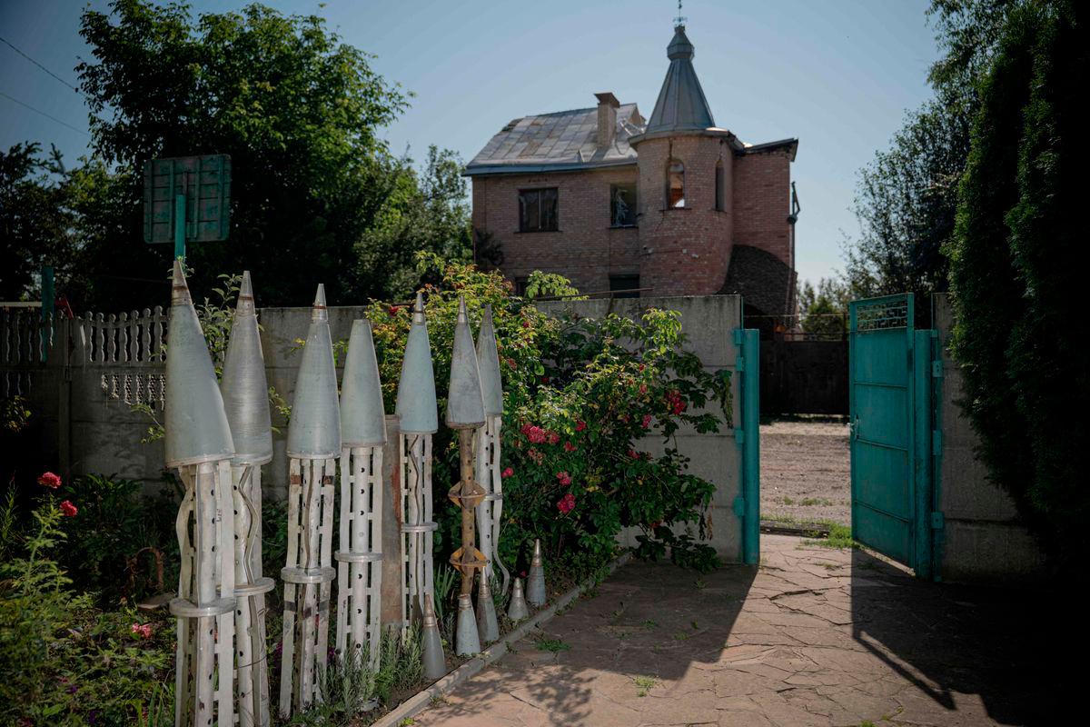 Collected remains of missiles in the courtyard near the house of Ukrainian farmer Petro Pylypaka in the de-occupied village of Ruski Tyshky, Kharkiv region on July 15, 2025, amid the Russian invasion of Ukraine. (Photo by Ivan SAMOILOV / AFP)