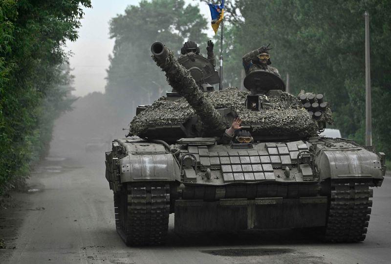 Ukrainian servicemen ride on a tank in Donetsk region on June 28, 2023, amid the Russian invasion of Ukraine. - AFPPIX