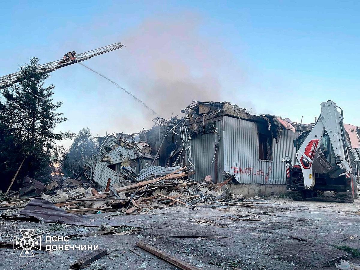 This handout picture taken and released by Ukrainian State Emergency Service on July 16, 2025 shows firefighters extinguishing a fire on a civilian installation following Russian strike in Dobropillia, Donetsk region, amid Russian invasion in Ukraine. - Handout / UKRAINIAN STATE EMERGENCY SERVICE / AFP