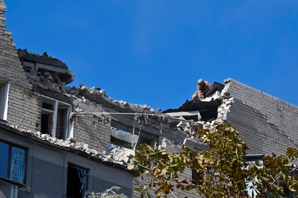 A picture shows the roof of a residential building damaged after shelling in Kharkiv on September 21, 2022, amid Russian invasion of Ukraine. - AFPPIX