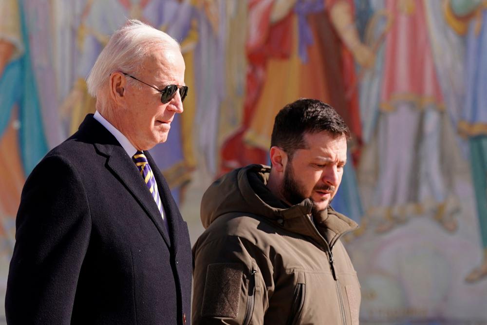 US President Joe Biden (L) walks next to Ukrainian President Volodymyr Zelensky (R) as he arrives for a visit in Kyiv on February 20, 2023. AFPPIX