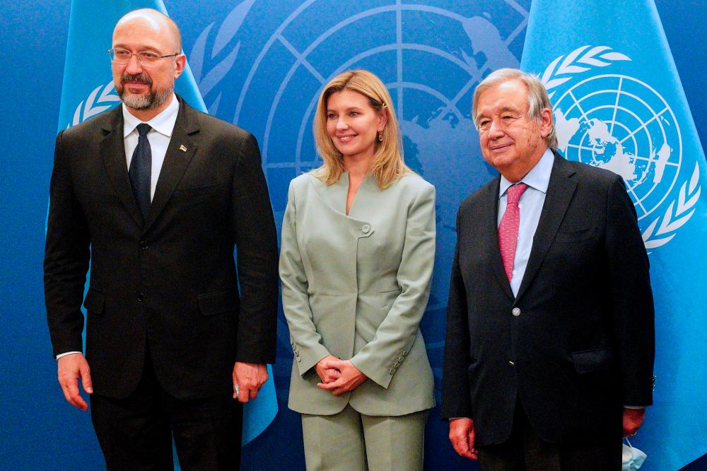 Ukraine's Prime Minister Denys Shmyhal (L), Ukraine's First Lady Olena Zelenska (C) and United Nations Secretary-General Antonio Guterres pose for photos before a meeting on the sidelines of the 77th session of the United Nations General Assembly at the UN headquarters in New York City on September 20, 2022. - AFPPIX