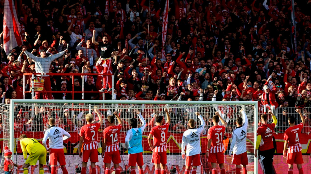 Union Berlin players celebrate with their fans after beating Wolfsburg to stay top of the Bundesliga, AFPPIX