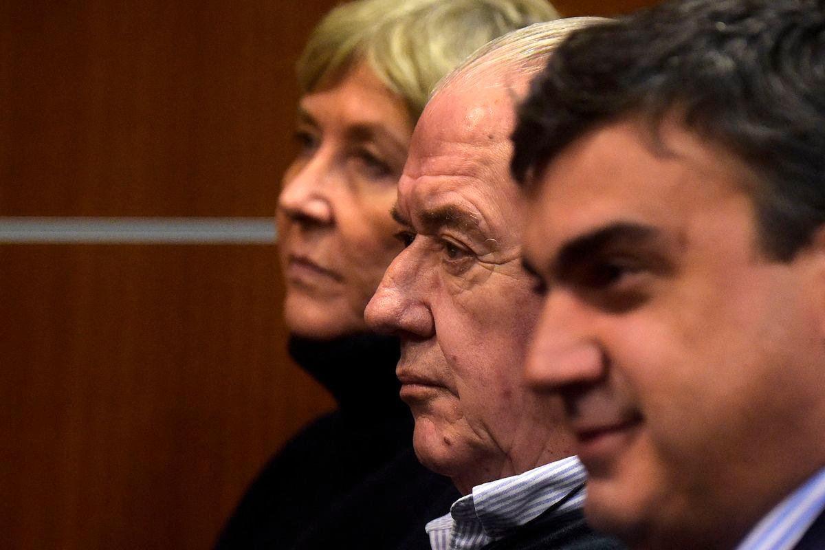 Defendants Ana Iewdiukow (L) and Pablo Carrasco (C), and a member of the legal team, Joaquin Toyos, attend the court hearing for the bankruptcy of the company Conexion Ganadera - AFPPix