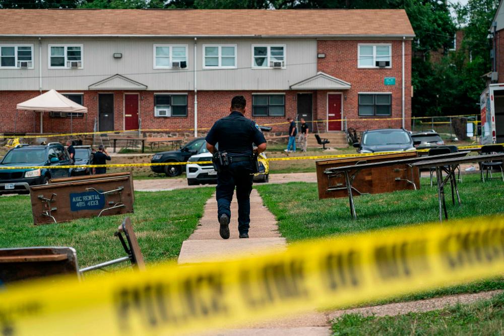 BALTIMORE, MARYLAND - JULY 2: Baltimore Police investigate the site of a mass shooting in the Brooklyn Homes neighborhood on July 2, 2023 in Baltimore, Maryland. AFPPIX