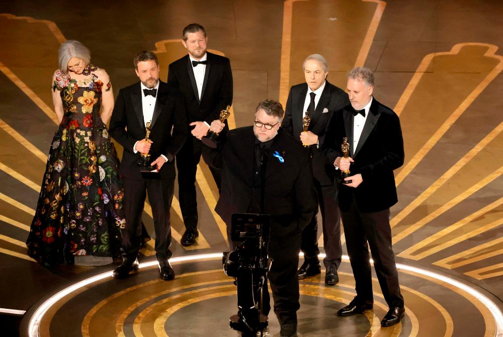 HOLLYWOOD, CALIFORNIA - MARCH 12: (L-R) Lisa Henson, Alexander Bulkley, Corey Campodonico, Guillermo del Toro, Gary Unger, and Mark Gustafson accept the Best Animated Feature Film award for “Guillermo del Toro’s Pinocchio” onstage during the 95th Annual Academy Awards at Dolby Theatre on March 12, 2023 in Hollywood, California. AFPPIX
