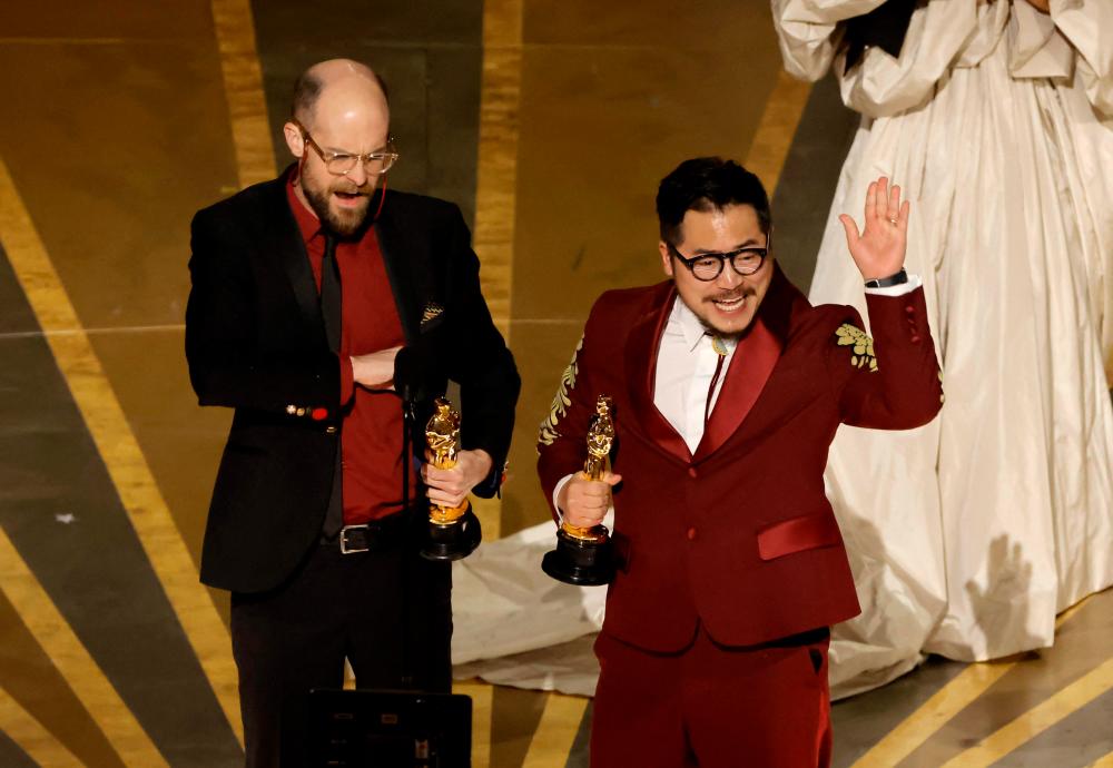 HOLLYWOOD, CALIFORNIA - MARCH 12: (L-R) Daniel Scheinert and Dan Kwan accept the Best Original Screenplay award for “Everything Everywhere All at Once” onstage during the 95th Annual Academy Awards at Dolby Theatre on March 12, 2023 in Hollywood, California. AFPPIX