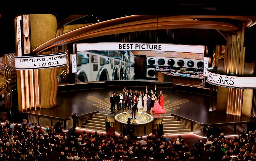 HOLLYWOOD, CALIFORNIA - MARCH 12: Cast and crew of “Everything Everywhere All at Once” accepts the Best Picture award onstage during the 95th Annual Academy Awards at Dolby Theatre on March 12, 2023 in Hollywood, California. AFPPIX