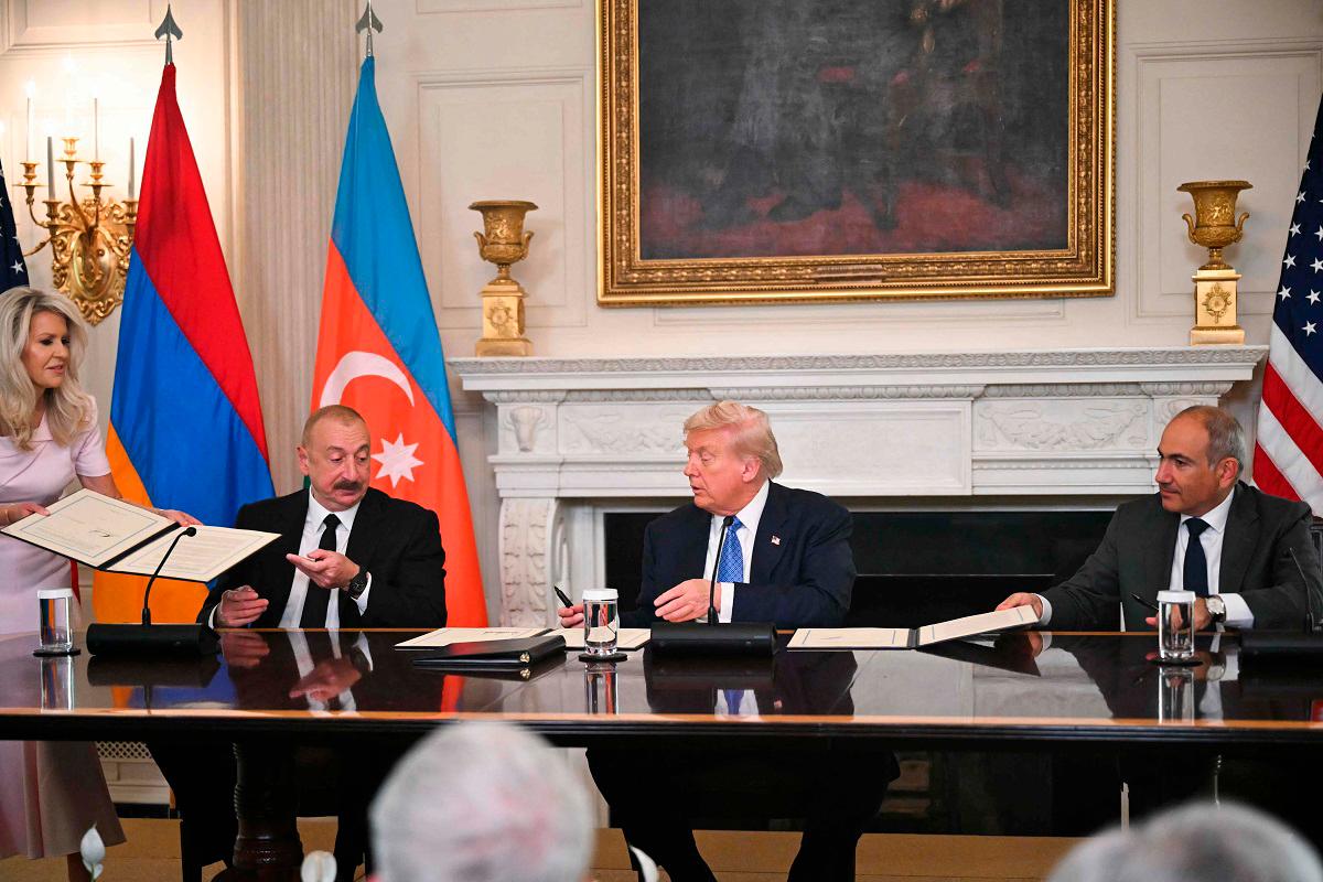 US President Donald Trump (C), Azerbaijani President Ilham Aliyev (L) and Armenian Prime Minister Nikol Pashinyan sign an agreement in the State Dining Room of the White House in Washington, DC, on August 8, 2025. US President Donald Trump said Friday that Armenia and Azerbaijan were committed to a permanent peace as he hosted a White House summit with the leaders of the two South Caucasus nations, which have fought for decades. - ANDREW CABALLERO-REYNOLDS / AFP