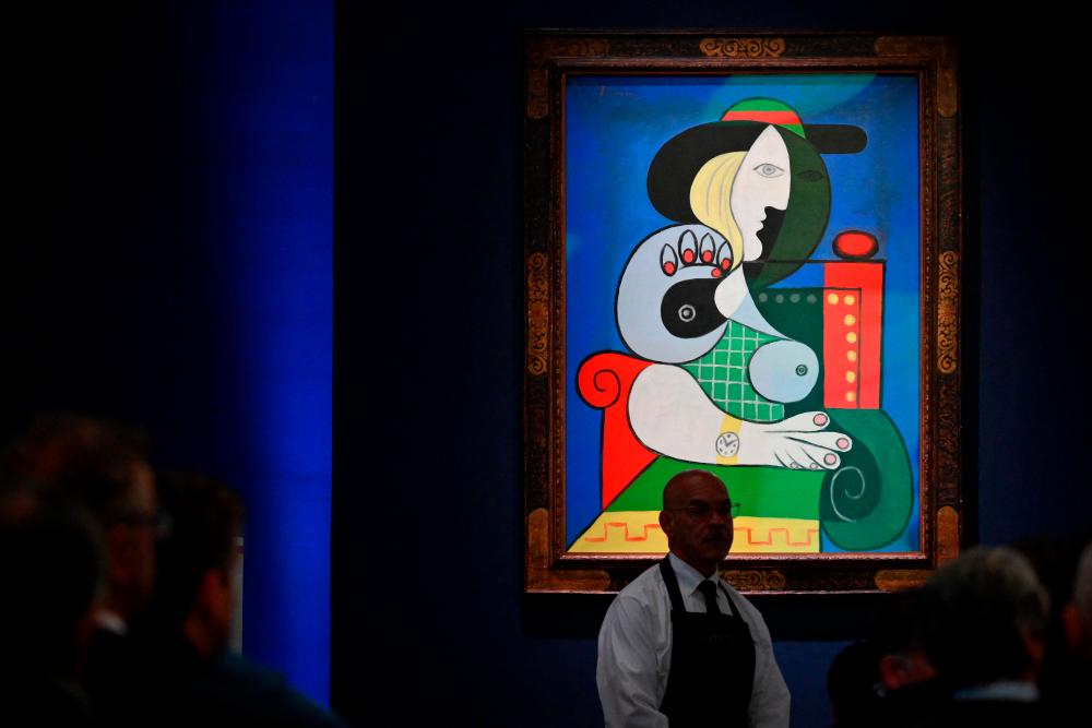 Sotheby’s employees take phone bids during the “The Emily Fisher Landau Collection: An Era Defined” auction for Pablo Picasso’s “Femme a la Montre” at Sotheby’s in New York City on November 8, 2023/AFPPix