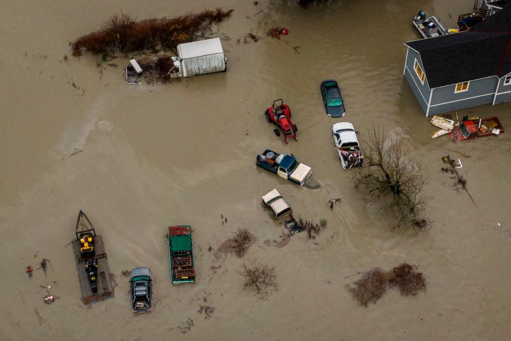 Filepix: In an aerial view, floodwaters surround a home and vehicles on December 6, 2023 in Stanwood, Washington. Atmospheric river conditions in the region brought heavy rains and flooding/AFPpix