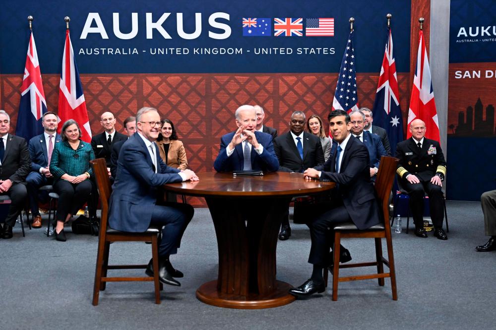 US President Joe Biden (C) participates in a trilateral meeting with British Prime Minister Rishi Sunak (R) and Australia’s Prime Minister Anthony Albanese (L) during the AUKUS summit on March 13, 2023, at Naval Base Point Loma in San Diego California. AUKUS is a trilateral security pact announced on September 15, 2021, for the Indo-Pacific region. AFPPIX