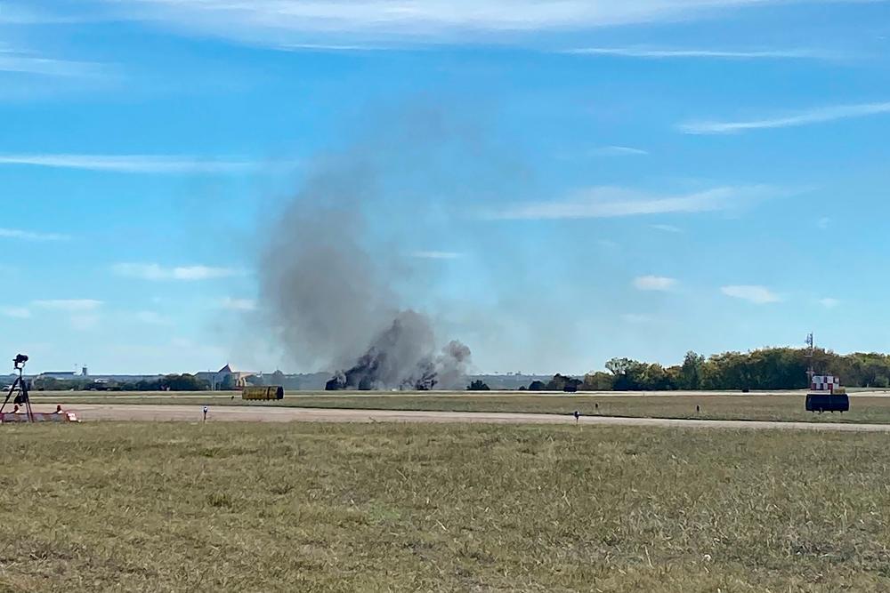 This image obtained from the Twitter account @GollyItsMollie, shows smoke rising from the crash after two planes collided mid-air during the Wings Over Dallas Airshow at Dallas Executive Airport, in Dallas, Texas, on November 12, 2022. - AFPPIX