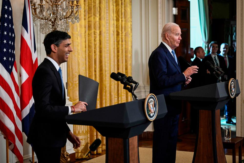 US President Joe Biden and British Prime Minister Rishi Sunak stop to answer more questions shouted from reporters as they go to leave a joint-press conference in the East Room of the White House in Washington, DC, on June 8, 2023. AFPPIX