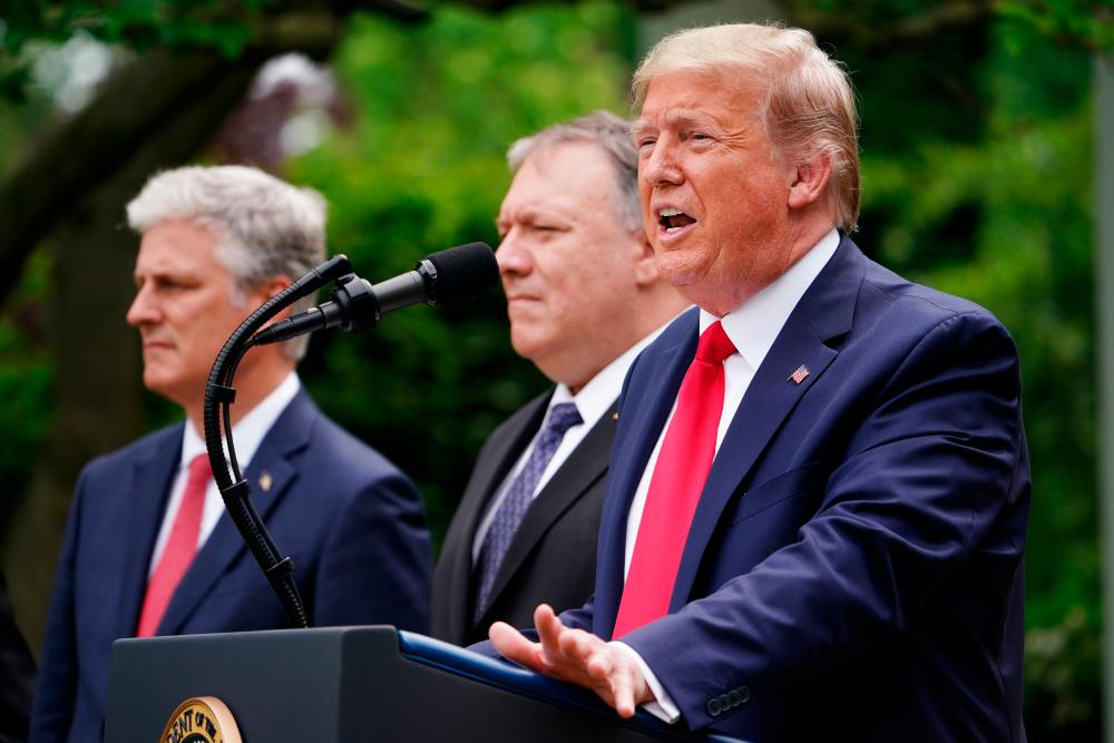 US National Security Advisor Robert O’Brien, and Secretary of State Mike Pompeo look on as US President Donald Trump speaks during a press conference on China in the Rose Garden of the White House in Washington, DC on May 29, 2020. — AFP