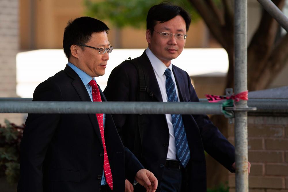 China's Vice Finance Minister Liao Min (L) leaves after deputy-level US-China trade talks in Washington, DC, on September 19, 2019. - AFP