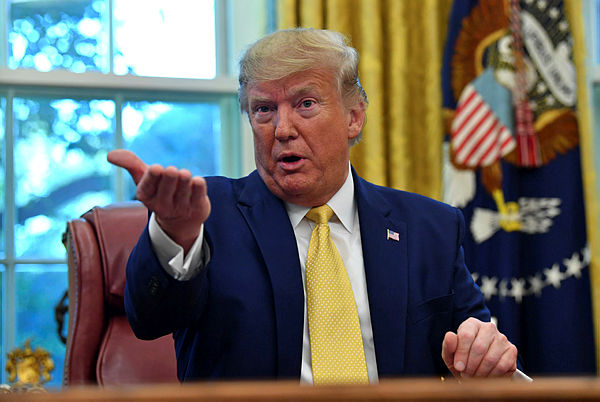 US President Donald Trump speaks after announcing and initial deal with China while meeting the special Envoy and Vice Premier of the People’s Republic of China Liu He at the Oval Office of the White House in Washington, DC on October 11, 2019. — AFP