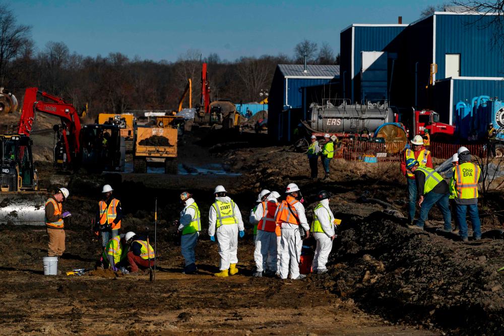 Ohio EPA and EPA contractors collect soil and air samples from the derailment site on March 9, 2023 in East Palestine, Ohio/AFPPix