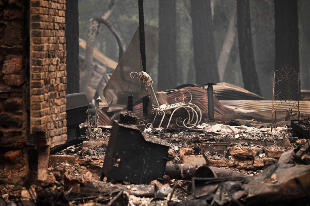 Homes and personal possessions burned in the Dixie Fire are still smoldering in the Indian Falls area of Plumas County, California on July 26, 2021. -AFP