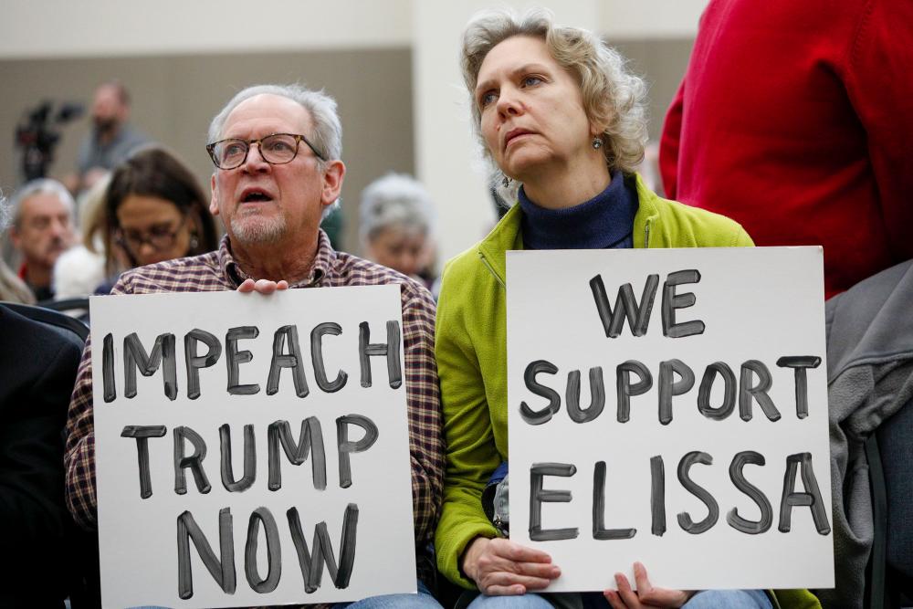Don Woodward and his wife Carole Zak of Rochester, Michigan wait to listen to US Representative Elissa Slotkin (D-MI) speak at a Town Hall meeting and discuss her decision to vote in favor of the impeachment of President Donald Trump on Dec 16, in Rochester, Michigan. — AFP
