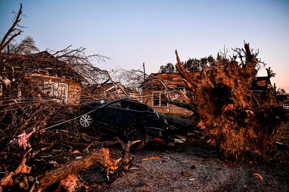 The remains of a house and cars are entangled in tree limbs in Rolling Fork, Mississippi, on March 25, 2023, after a tornado touched down in the area. AFPPIX