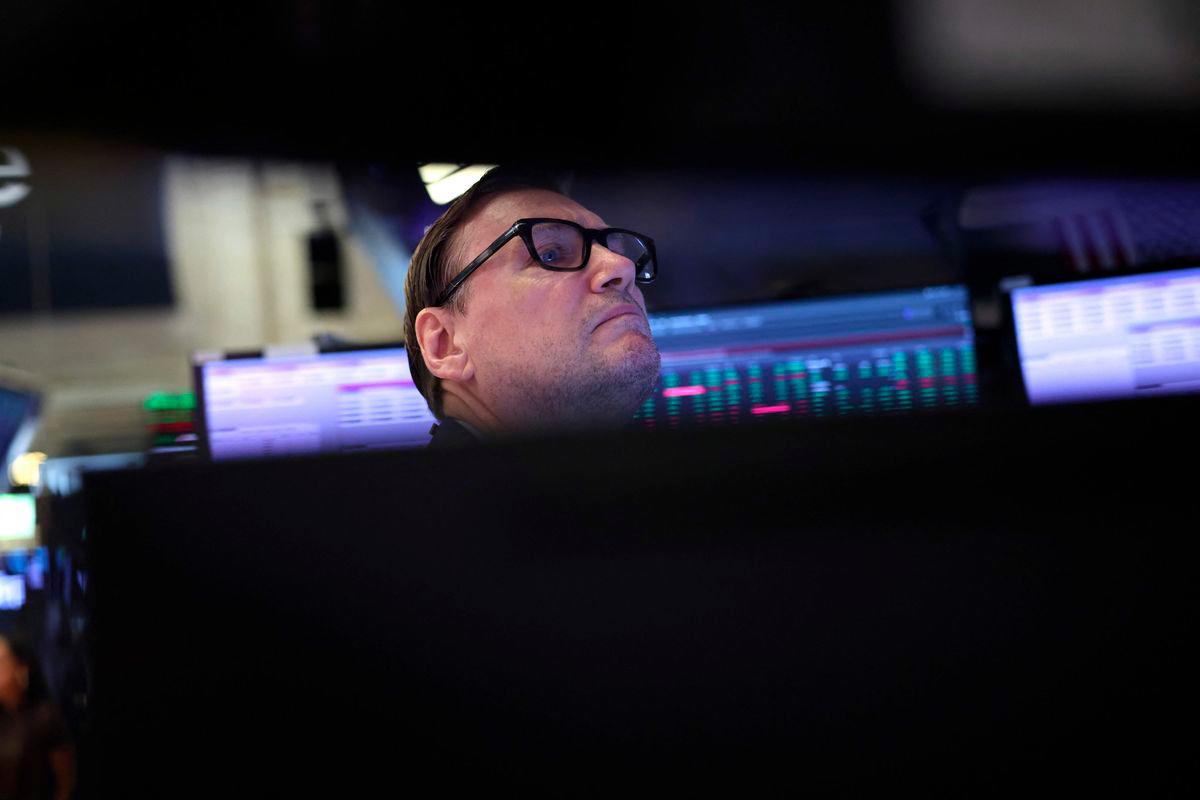A trader works on the floor of the New York Stock Exchange (NYSE) at the opening bell on August 11, 2025, in New York City. Wall Street stocks opened mixed Monday, ahead of a key US inflation report and as the clock ticked down to a deadline for higher tit-for-tat tariffs to return between Washington and Beijing. - AFPPIX
