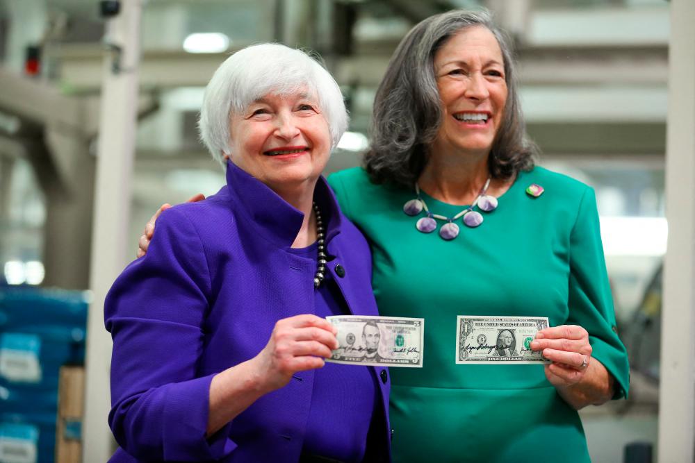Yellen and Treasurer Marilynn Malerba holding the first US currency notes bearing their signatures at the Bureau of Engraving and Printing Western Currency Facility in Fort Worth, Texas, on Thursday. – AFPpic