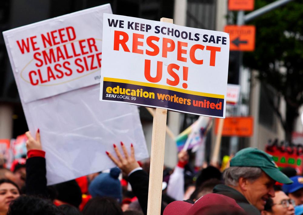 Los Angeles Unified School District (LAUSD) workers and supporters rally outside LAUSD headquarters on the first day of a strike over a new contract on March 21, 2023 in Los Angeles, California/AFPPix