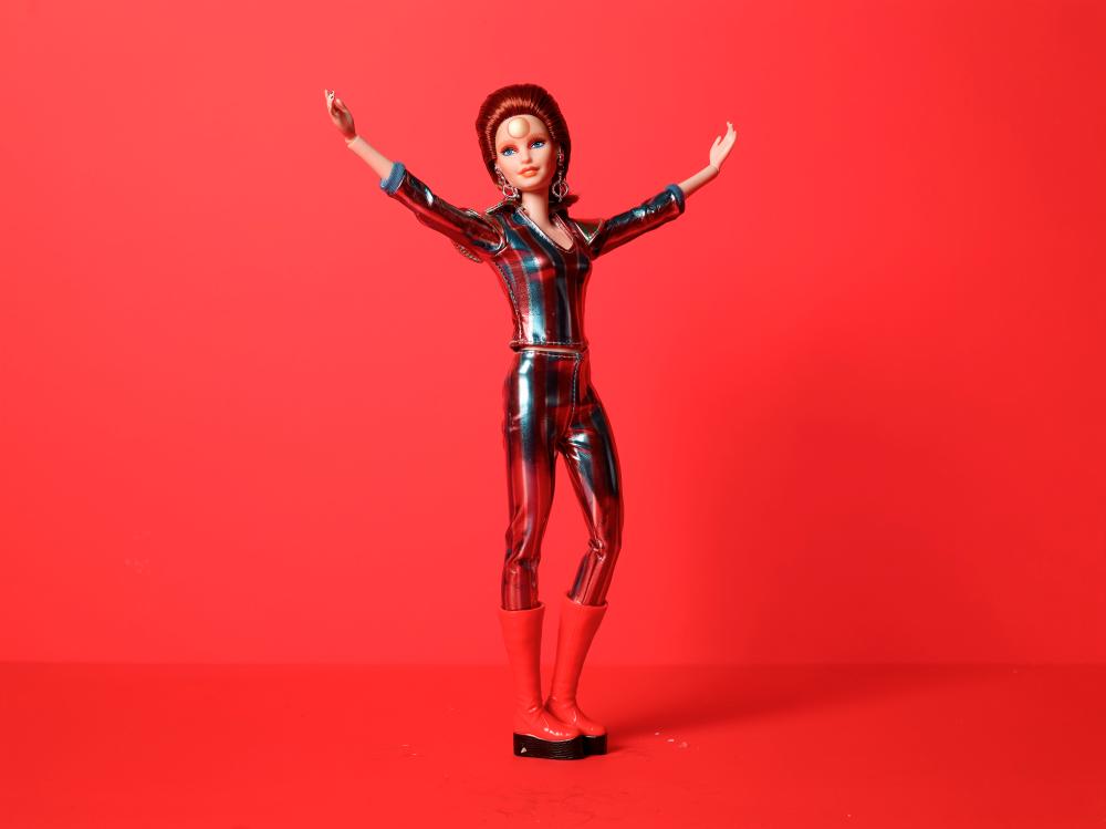 This handout photo released by Mattel on July 11, 2019 shows the David Bowie Doll Barbie. A limited edition David Bowie Barbie was unveiled on July 11 by toymaker Mattel to honor the 50th anniversary of the release of the iconic singer’s hit single “Space Oddity.” The doll, sporting a striped metallic jumpsuit with matching platform red boots and cosmic accessories, symbolizes Bowie’s bisexual alien messenger alter-ego Ziggy Stardust. - AFP PHOTO / MATTEL