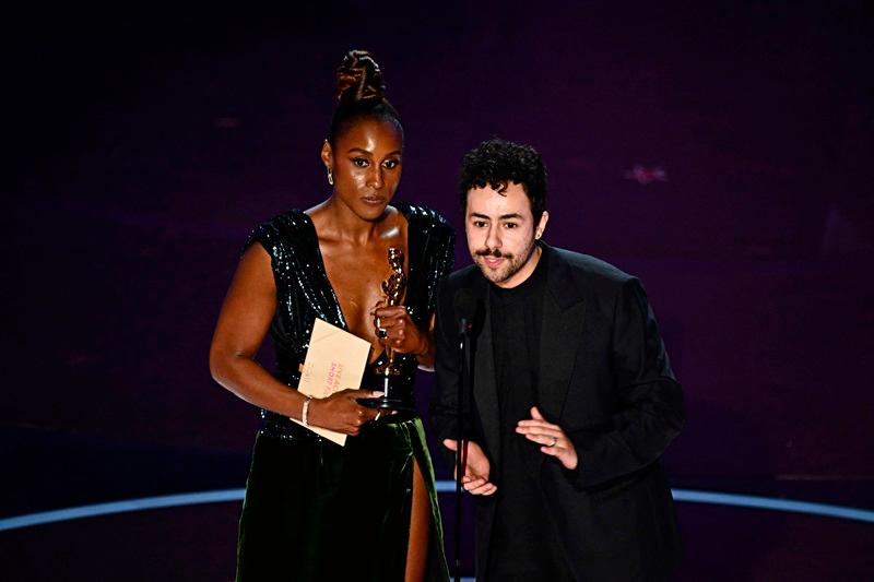 $!US actress Issa Rae (L) and US comedian Ramy Youssef accept the award for Best Live Action Short Film on behalf of US filmmaker Wes Anderson onstage for The Wonderful Story of Henry Sugar//AFP