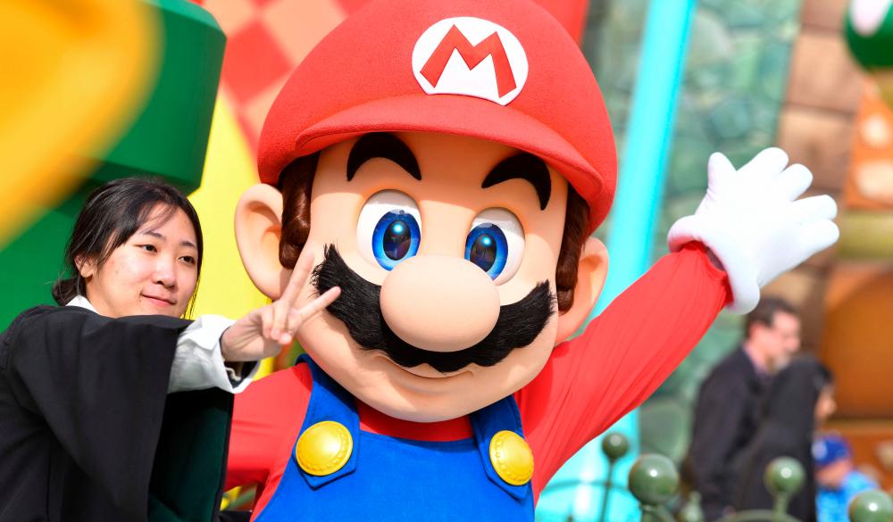 A guest takes a photo with Mario during a preview of Super Nintendo World at Universal Studios in Los Angeles, California, on January 13, 2023/AFPPix