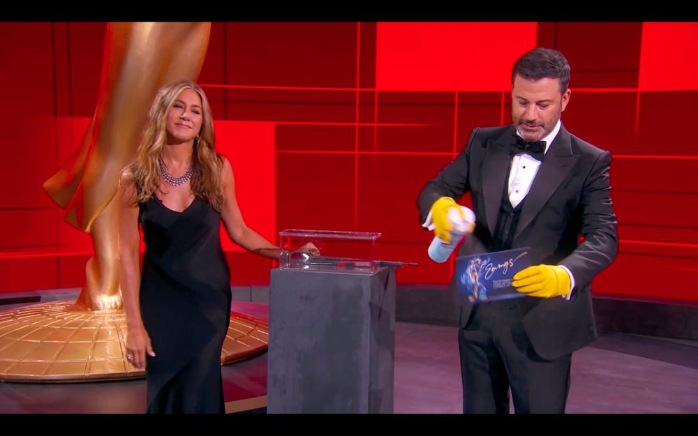 This handout screen shot released courtesy of American Broadcasting Companies, Inc. / ABC shows host Jimmy Kimmel and actress Jennifer Aniston disinfecting ballots during the 72nd Primetime Emmy Awards ceremony held virtually on Sept 20, 2020. — AFP