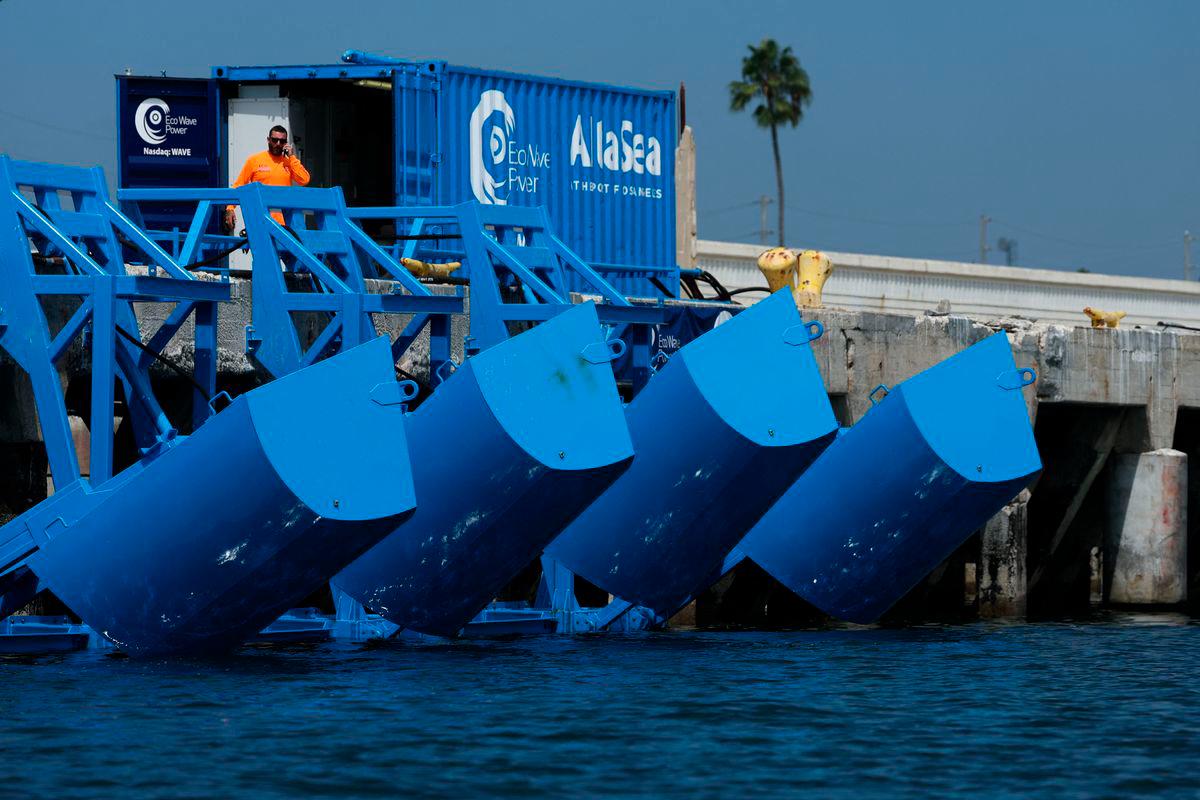 Floaters are raised out of the water during a demonstration of Eco Wave Power electricity generation technology using the power of ocean waves in the harbor at AltaSea at the Port of Los Angeles in San Pedro, California, on August 26, 2025. (Photo by Patrick T. Fallon / AFP)