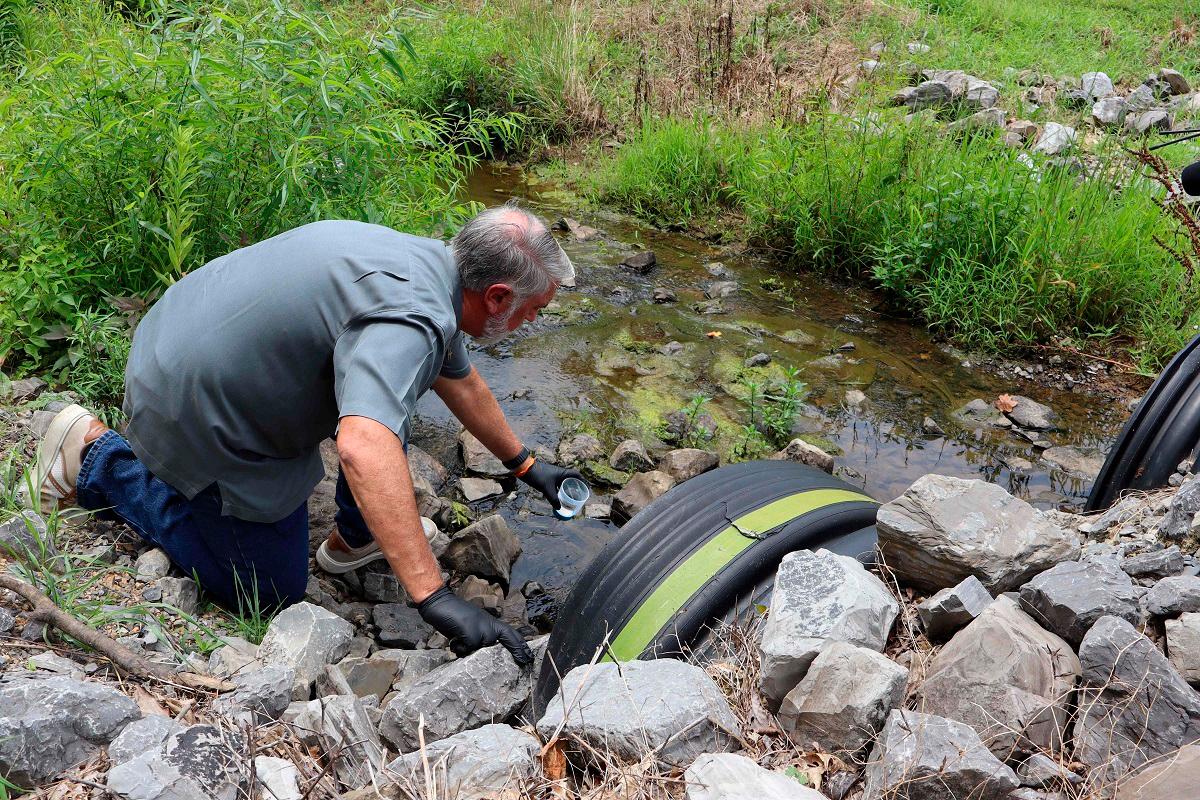 Civil engineer and water quality expert Bob Bowcock conducts a test for forever chemicals on a sample from a property in Dalton, Georgia, on June 12, 2025. - Issam AHMED / AFP