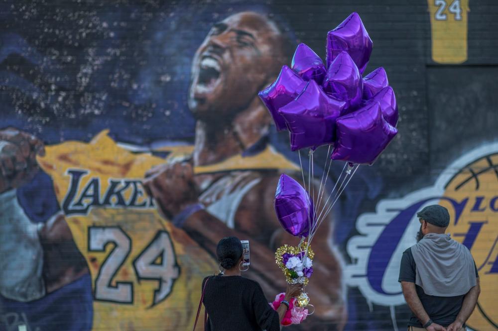 Fans visit a mural of former NBA star Kobe Bryant who, along with his 13-year-old daughter Gianna, died Jan 26 in a helicopter crash, on Jan 28, in Los Angeles, California. — AFP