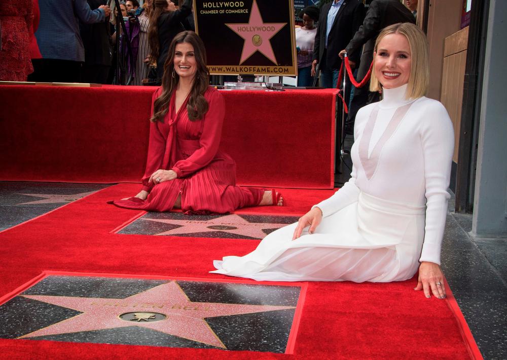 Actresses Idina Menzel (L) and Kristen Bell (R) are honored with stars on the Hollywood Walk of Fame, in Hollywood, California on November 19, 2019. / AFP / Mark RALSTON