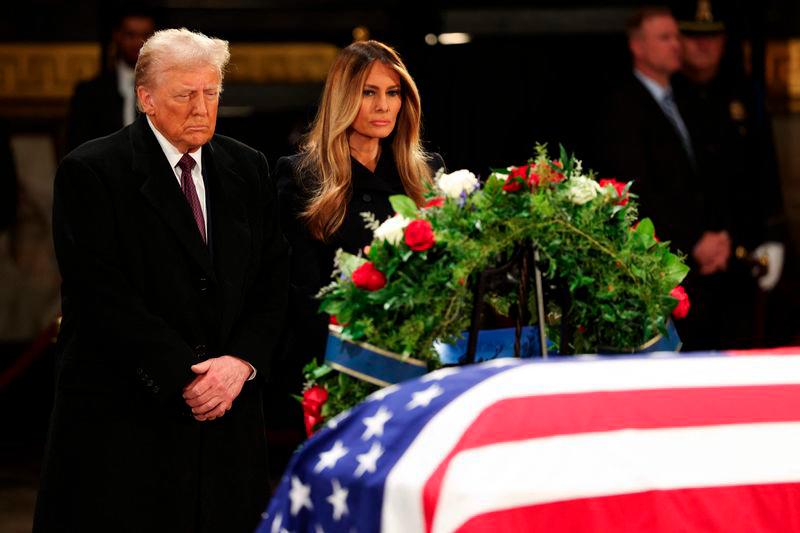 President-elect Donald Trump and his wife former first lady Melania Trump visit the flag-draped casket of former U.S. President Jimmy Carter lies - AFPpix