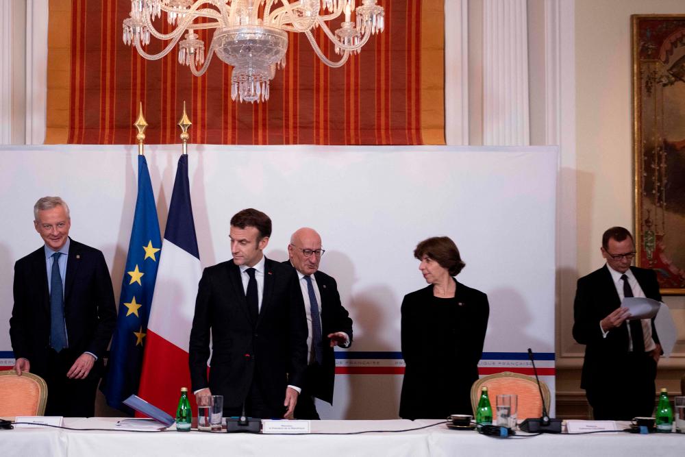 Macron (second from left) arriving for a meeting on cooperation and research on civil nuclear energy, at the French ambassador’s residence in Washington on Wednesday. – AFPpic