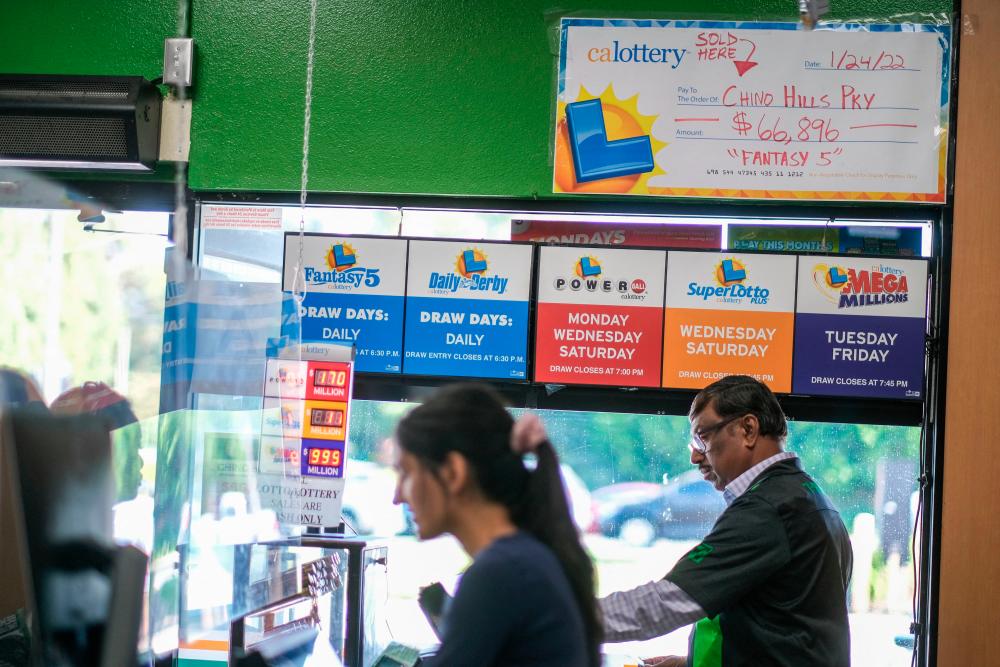 People wait in line to buy their Mega Millions lottery tickets at a 7-Eleven convenience store in Chino Hills, California, July 28, 2022. AFPPIX