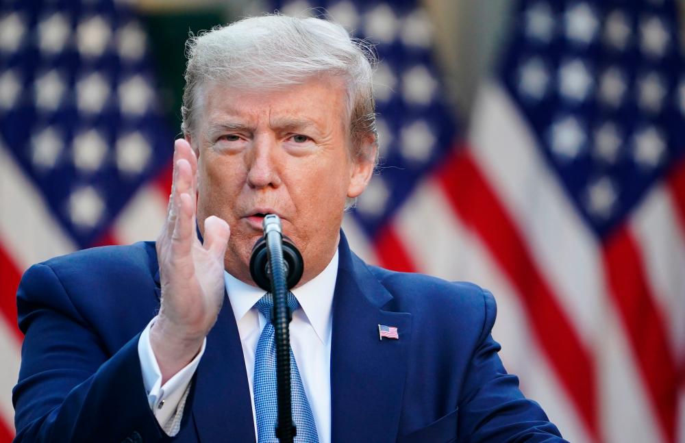 US President Donald Trump gestures as he speaks during the daily briefing on the novel coronavirus, which causes COVID-19, in the Rose Garden of the White House on April 15, 2020, in Washington, DC. — AFP
