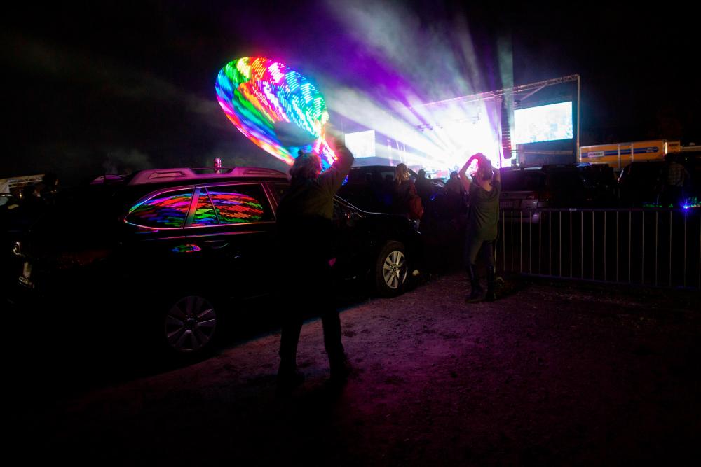 $!Attendees watch the The Disco Biscuits perform during the Montage Mountain rave on October 23, 2020 in Scranton, Pennsylvania. / AFP / Kena Betancur