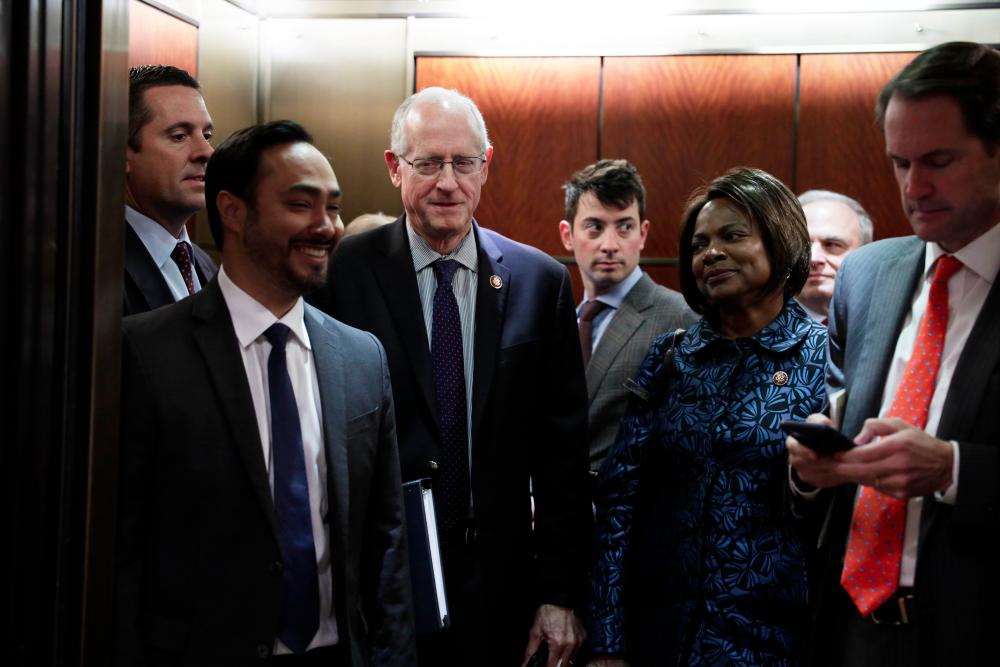Ranking member of House Intelligence Committee Devin Nunes (R-CA) (Far L), and Reps. Joaquin Castro (D-TX), Mike Conaway (R-TX) and Val Demings (D-FL) take an elevator to leave after a closed markup meeting of the report on the impeachment inquiry into President Donald Trump Dec 3, on Capitol Hill in Washington, DC. — AFP