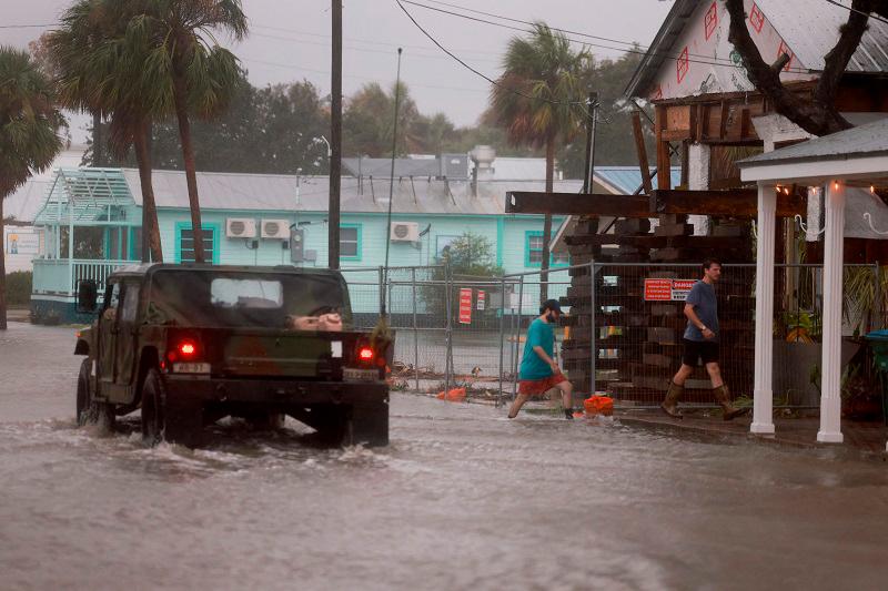 CEDAR KEY, FLORIDA - AUGUST 05: A Florida National Guard vehicle drives through a flooded street caused by the rain and storm surge from Hurricane Debby on August 05, 2024, in Cedar Key, Florida. Hurricane Debby brings rain storms and high winds along Florida’s Big Bend area. - Joe Raedle/Getty Images/AFP
