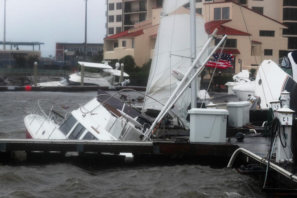Damaged boats are seen in the Palafox Pier Yacht harbor marina after Hurricane Sally passed through the area on Sept 16, 2020 in Pensacola, Florida. — AFP