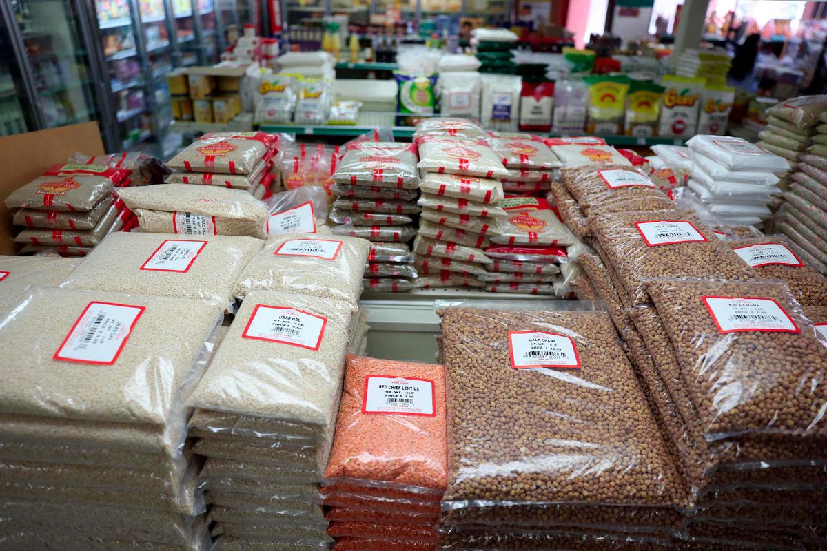 Bags of dal, lentils, chana, and other groceries imported from India are displayed for sale at Farm Fresh grocery as small businesses face tariffs, rising costs, and supply chain uncertainties in the Little India neighborhood of Artesia, California on August 7, 2025. - AFPPIX